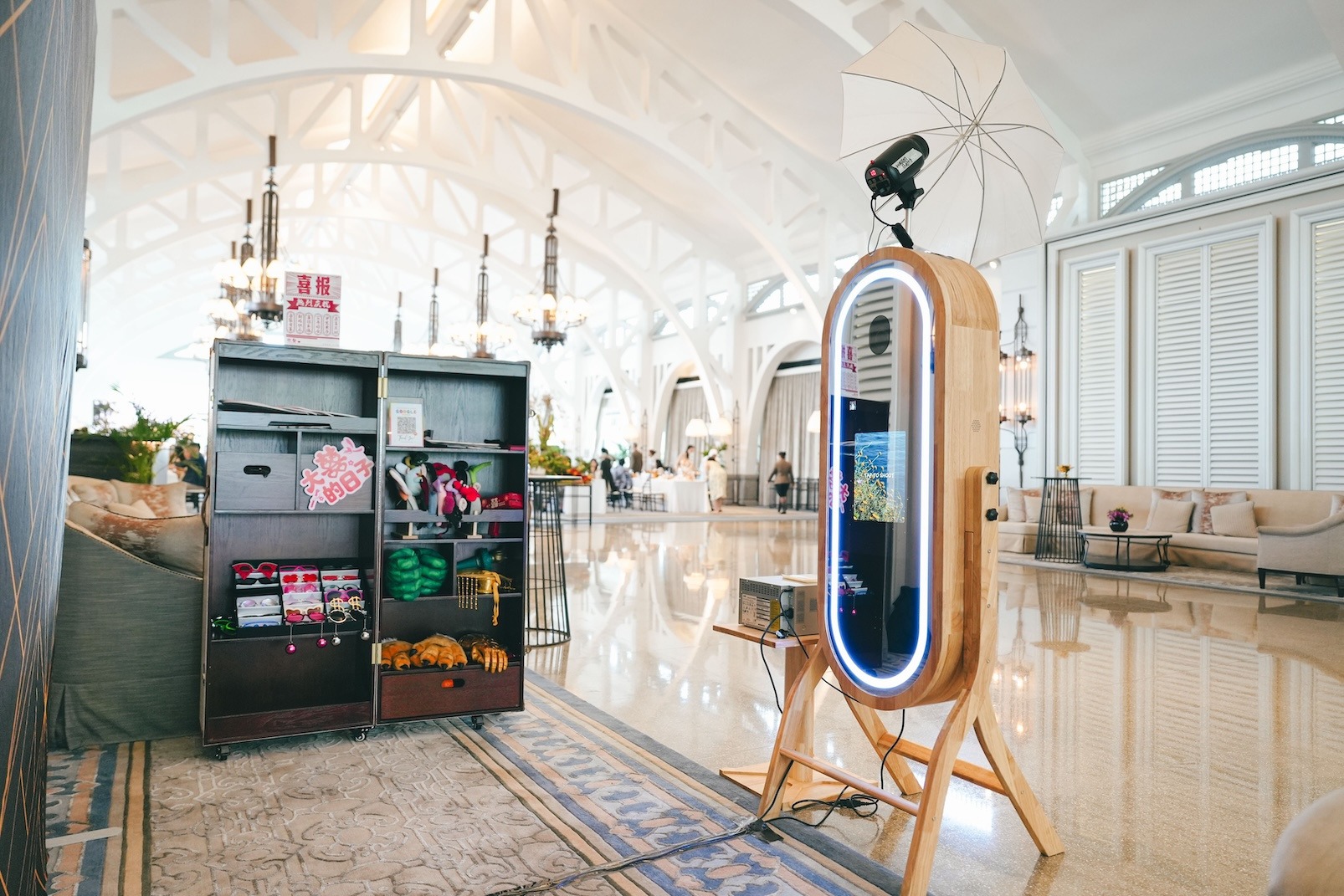 Wedding Photobooth with a wooden camera and organised prop cabinet
