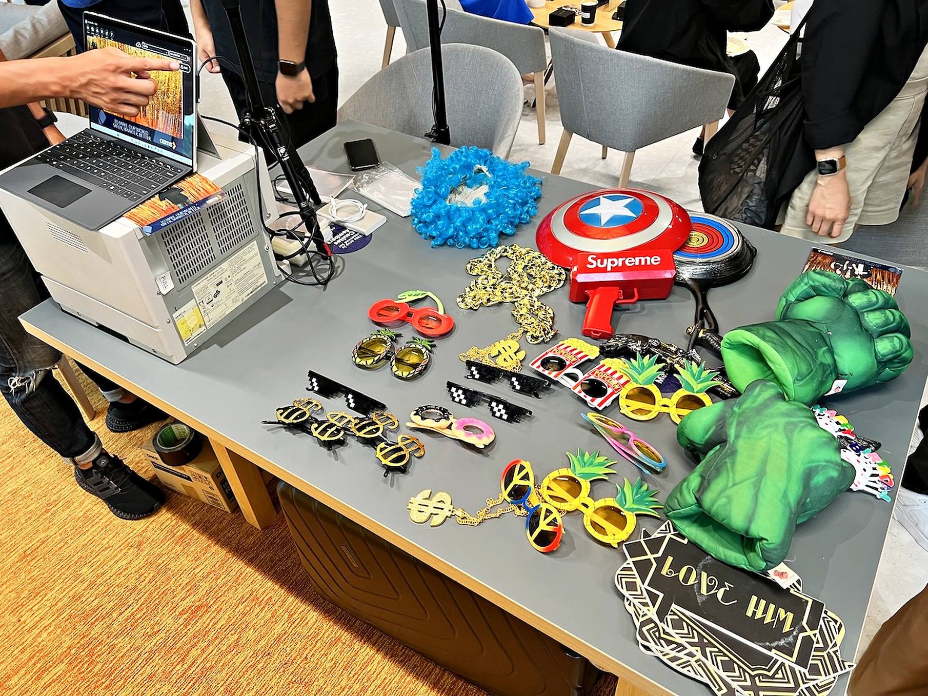 Photobooth props arranged on a table with novelty glasses and playful handheld accessories
